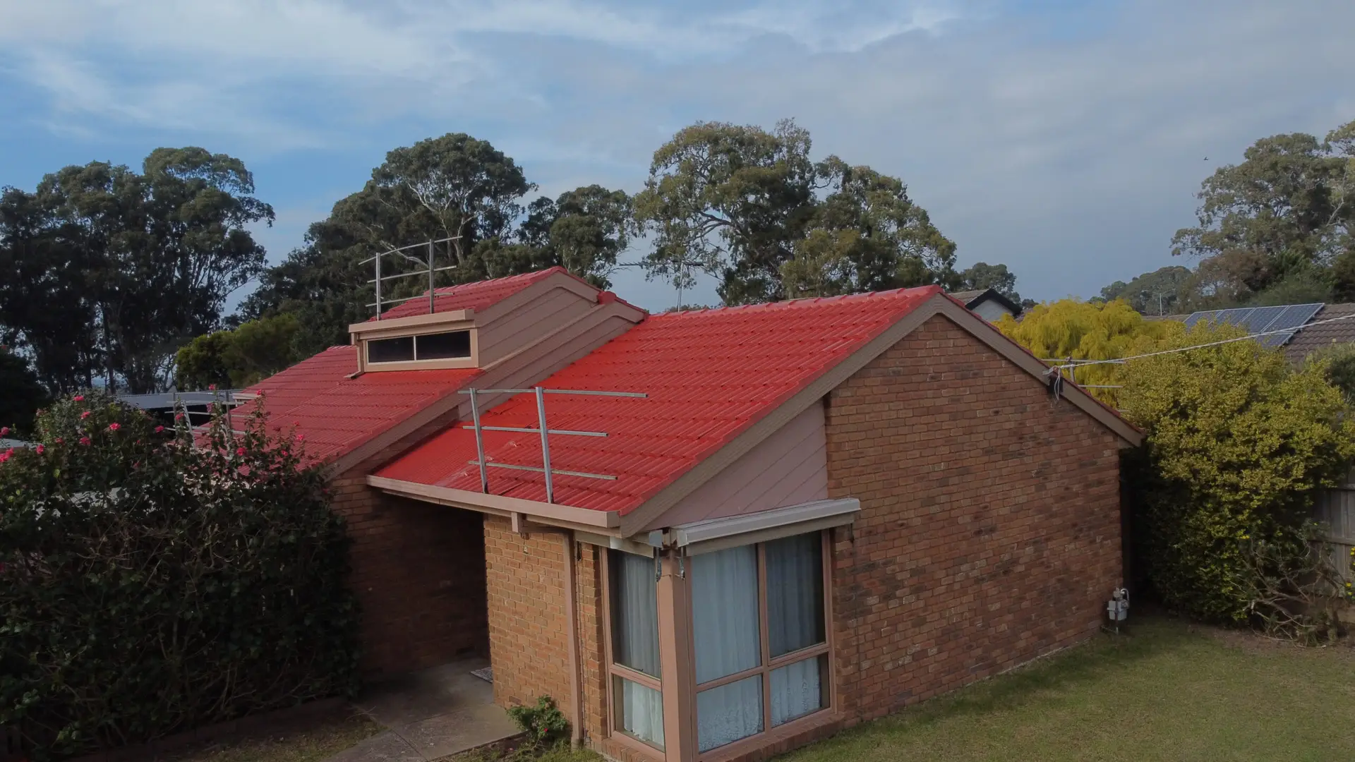 Side view photo of a newly painted roof in hampton