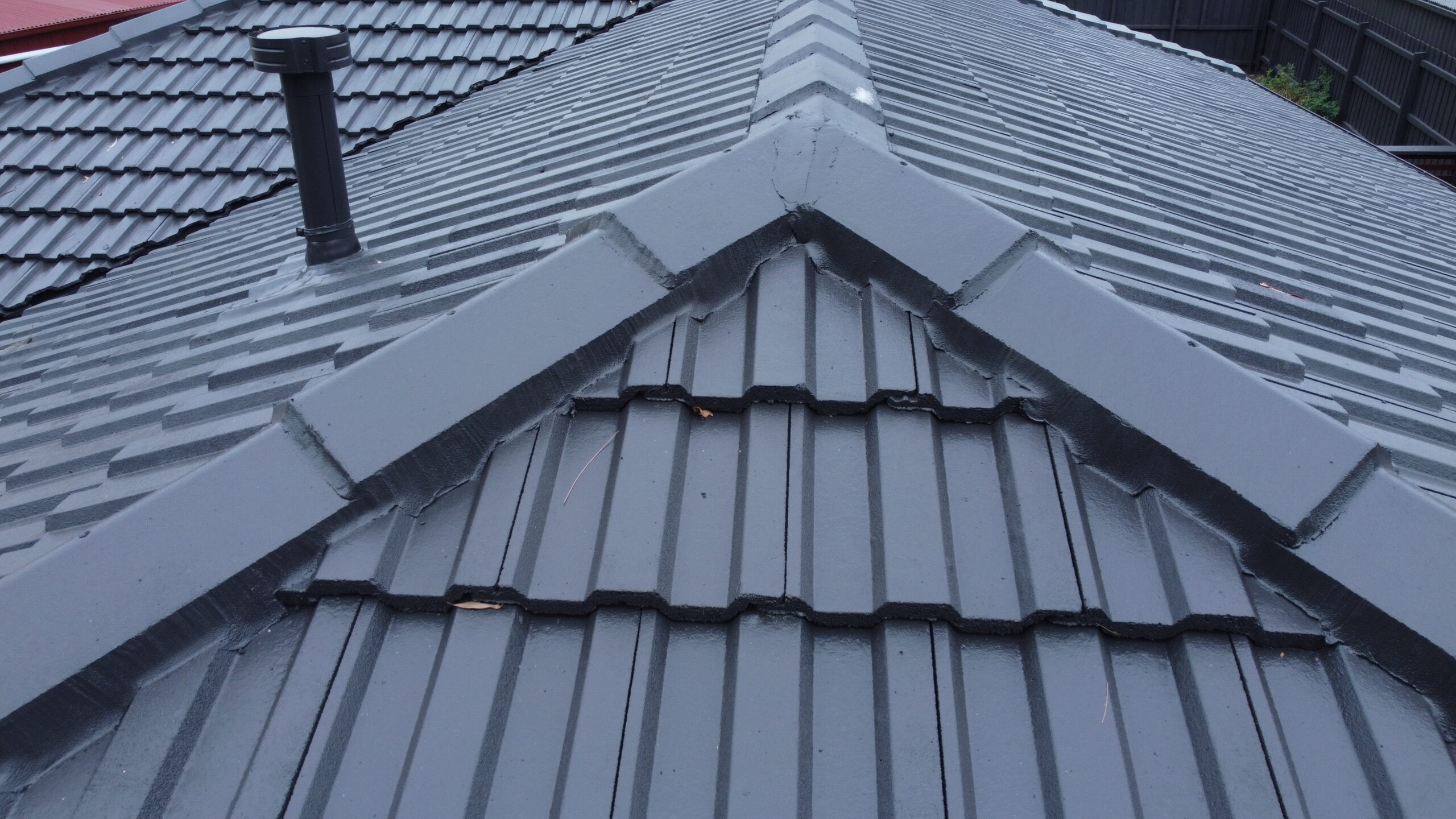 Freshly restored tile roof in Ferntree Gully with sealed ridges and clean finish.