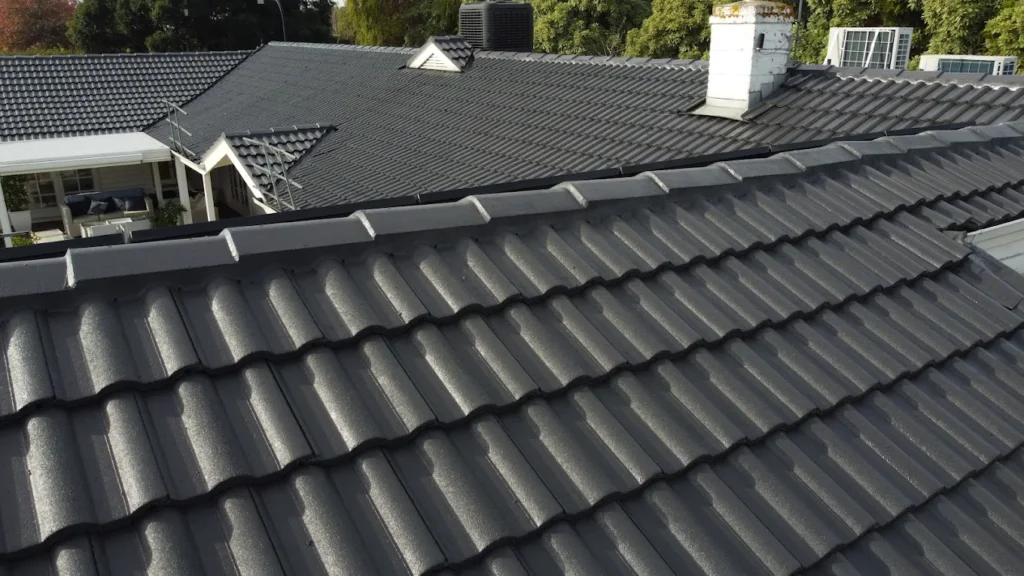 Oakleigh property after roof repair, showing cleaned and repointed tiles with patch repairs to stop minor leaks.