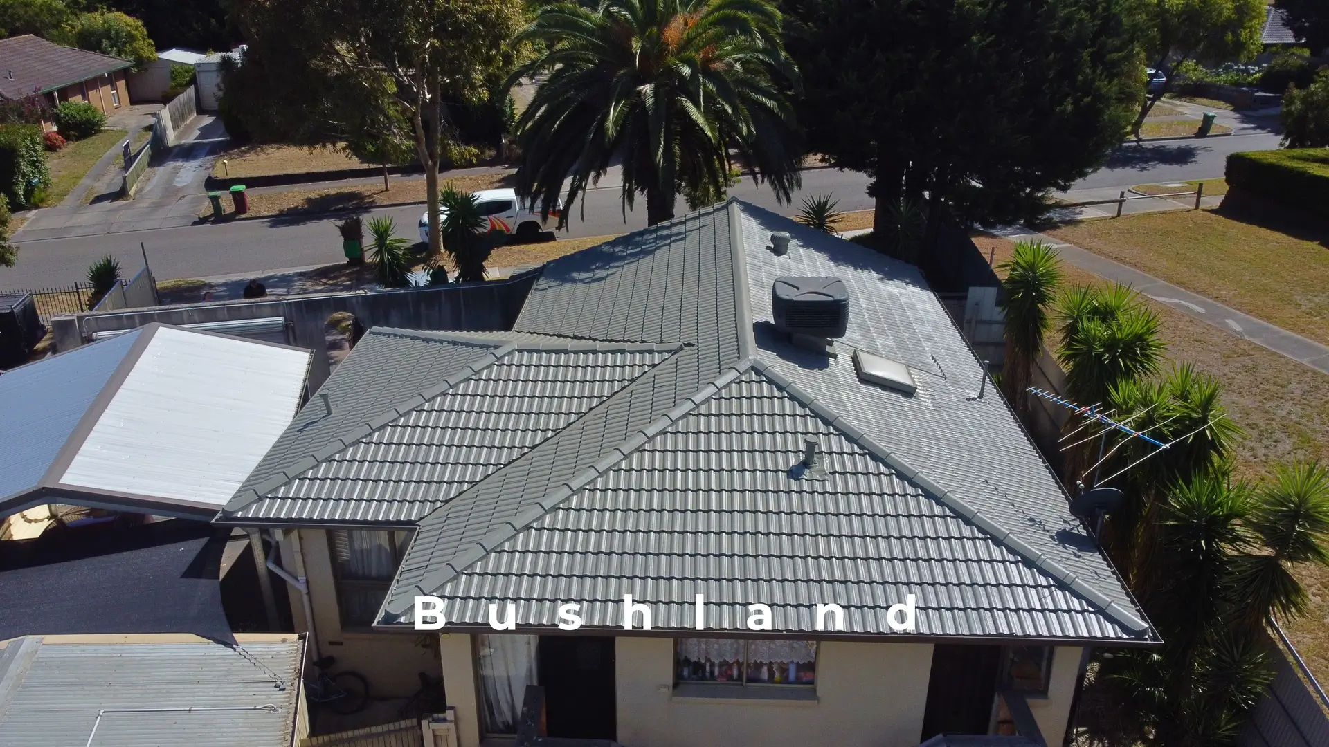 Aerial view: tiled grey roof Bushland, Melbourne restoration.